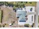 Aerial view of home shows a large lot, lush greenery, and nearby amenities creating a serene and convenient setting at 240 Spaniards Rd, Placida, FL 33946