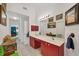 Bright bathroom features a red double vanity, ample lighting, and artistic decor creating a stylish space at 240 Spaniards Rd, Placida, FL 33946