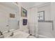 Charming bathroom features a shower/tub, blue mosaic tile detail, and vanity with a view of artwork at 240 Spaniards Rd, Placida, FL 33946