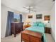 Cozy bedroom with a ceiling fan, window, side tables, art, and blue bedding creating a serene space at 240 Spaniards Rd, Placida, FL 33946