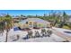 Captivating yellow home featuring lush landscaping, a well-manicured lawn, and a welcoming entrance at 240 Spaniards Rd, Placida, FL 33946