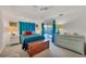 Bright main bedroom featuring a closet, a comfortable bed and access to the lanai at 240 Spaniards Rd, Placida, FL 33946