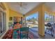 Screened patio with a colorful dining set offers an inviting outdoor space for dining and relaxation at 240 Spaniards Rd, Placida, FL 33946