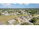 Aerial view of a residential neighborhood featuring homes with well-maintained lawns and mature trees at 26506 Copiapo Cir, Punta Gorda, FL 33983