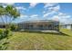Backyard view featuring screened-in lanai and pool at 26506 Copiapo Cir, Punta Gorda, FL 33983
