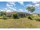 Backyard view with covered lanai, pool, and landscaping at 26506 Copiapo Cir, Punta Gorda, FL 33983