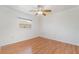Standard bedroom features wood floors, fan, and a window at 26506 Copiapo Cir, Punta Gorda, FL 33983