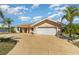 Charming single-story home featuring a 2-car garage, well-maintained landscaping, and an American flag at 26506 Copiapo Cir, Punta Gorda, FL 33983