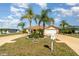 Inviting single-Gathering home with a wide driveway, mature palm trees, and manicured landscaping at 26506 Copiapo Cir, Punta Gorda, FL 33983