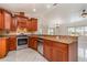 Gourmet kitchen featuring granite countertops, stainless steel appliances, and custom cabinetry at 26506 Copiapo Cir, Punta Gorda, FL 33983