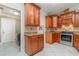 Kitchen features stainless oven and plentiful wooden cabinets at 26506 Copiapo Cir, Punta Gorda, FL 33983