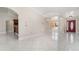 Bright and airy living area featuring tiled floors, an open layout, and a view of adjacent kitchen at 26506 Copiapo Cir, Punta Gorda, FL 33983