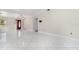 Bright living room features tile flooring and a red front door at 26506 Copiapo Cir, Punta Gorda, FL 33983