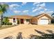 Open-concept living space featuring tile flooring, a decorative chandelier, and a clear view of the front entrance at 26506 Copiapo Cir, Punta Gorda, FL 33983