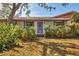 Eye-level view of the front door, featuring unique details and a vibrant purple color at 3006 42Nd W St, Bradenton, FL 34205