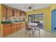 Open kitchen dining area featuring a decorative backsplash and access to the screened patio at 3006 42Nd W St, Bradenton, FL 34205