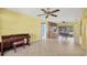 Spacious living room with tile flooring, ceiling fans, and a kitchen/dining area at 3006 42Nd W St, Bradenton, FL 34205