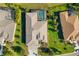 Aerial view of a private residence with a screened-in pool, a lush green lawn, and mature trees surrounding the property at 391 Snapdragon Loop, Bradenton, FL 34212