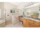 Well-lit bathroom featuring marble countertops, a glass shower, and neutral tile at 391 Snapdragon Loop, Bradenton, FL 34212