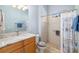 Bathroom featuring granite countertops, a ceramic tile shower, and beach themed accessories at 391 Snapdragon Loop, Bradenton, FL 34212