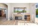 Living room with a stone fireplace and view of the pool at 391 Snapdragon Loop, Bradenton, FL 34212