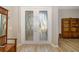 Welcoming foyer featuring a decorative front door with frosted glass and hardwood floors at 391 Snapdragon Loop, Bradenton, FL 34212