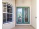Elegant front door with decorative glass inserts, complemented by a nearby window at 391 Snapdragon Loop, Bradenton, FL 34212