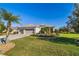 Charming single-story home with a well-manicured lawn and three-car garage, lush landscaping and a paver driveway at 391 Snapdragon Loop, Bradenton, FL 34212