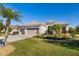 Charming single-story home with a well-manicured lawn and three-car garage, lush landscaping and a paver driveway at 391 Snapdragon Loop, Bradenton, FL 34212