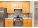 Kitchen features stainless steel appliances, wooden cabinetry and granite countertops at 391 Snapdragon Loop, Bradenton, FL 34212