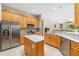 Modern kitchen featuring stainless steel appliances, granite countertops, and easy access to the living areas at 391 Snapdragon Loop, Bradenton, FL 34212