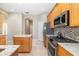 Modern kitchen with island, stainless steel appliances, and gas range, perfect for culinary enthusiasts at 391 Snapdragon Loop, Bradenton, FL 34212