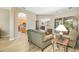 Open-concept living room with neutral tones, sliding glass doors to pool, and easy access to kitchen at 391 Snapdragon Loop, Bradenton, FL 34212