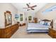 Bright and airy main bedroom with a ceiling fan and views to the outdoors at 391 Snapdragon Loop, Bradenton, FL 34212