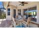 Charming outdoor dining area on a screened lanai with a ceiling fan at 391 Snapdragon Loop, Bradenton, FL 34212