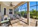 Spacious covered patio with seating, grill, and view of the backyard at 391 Snapdragon Loop, Bradenton, FL 34212