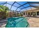 Stunning screened-in pool surrounded by lush landscaping, creating a private oasis at 391 Snapdragon Loop, Bradenton, FL 34212
