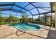 Relaxing screened-in pool area with clear blue water, a spa, and a tiled deck at 391 Snapdragon Loop, Bradenton, FL 34212