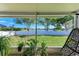 Backyard overlooking the lake, bordered by a white fence, and shady trees at 4108 Kingsfield Dr, Parrish, FL 34219