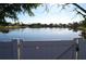 Scenic view of the calm lake beyond the white fence showcasing the natural beauty surrounding the property at 4108 Kingsfield Dr, Parrish, FL 34219