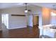 Spacious living room featuring modern ceiling fan, barn door and elegant marble countertop details in adjoining spaces at 4108 Kingsfield Dr, Parrish, FL 34219