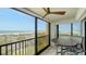 Relaxing balcony features a ceiling fan, tile flooring, and spectacular views of the gulf coast at 420 Beach Rd # 502, Sarasota, FL 34242