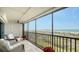 Expansive tiled balcony overlooking the beach features comfortable seating and potted plants at 420 Beach Rd # 502, Sarasota, FL 34242