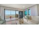 Cozy living room with ocean view, sliding glass doors to screened balcony at 420 Beach Rd # 502, Sarasota, FL 34242