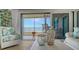 Inviting living room with ocean views, sliding doors to the balcony, and tasteful decor at 420 Beach Rd # 502, Sarasota, FL 34242