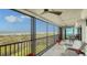 Spacious tiled balcony with outdoor seating, ceiling fans, and sweeping views of the gulf at 420 Beach Rd # 502, Sarasota, FL 34242