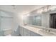 Bathroom featuring dual sinks and a large mirror at 420 Beach Rd # 502, Sarasota, FL 34242