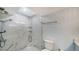 Bathroom featuring a glass enclosed shower and marble patterned walls at 420 Beach Rd # 502, Sarasota, FL 34242