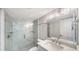 Bright bathroom featuring a glass enclosed shower and marble patterned walls at 420 Beach Rd # 502, Sarasota, FL 34242