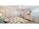 Well lit bedroom featuring coastal themed decor, ceiling fan, and hardwood floors at 420 Beach Rd # 502, Sarasota, FL 34242